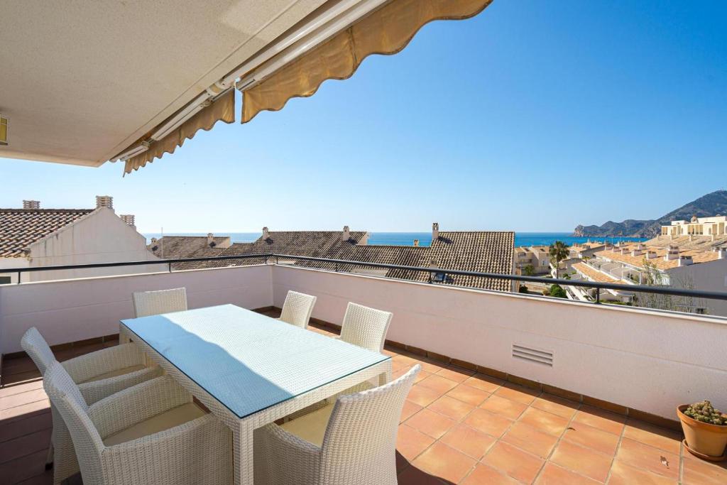 a table and chairs on a balcony with a view of the ocean at Apartament Altea Spaniahome in Altea
