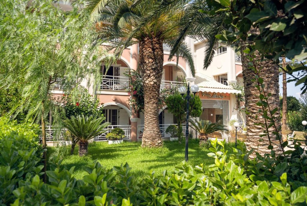 a palm tree in front of a building at Villa Maria Laganas in Laganas