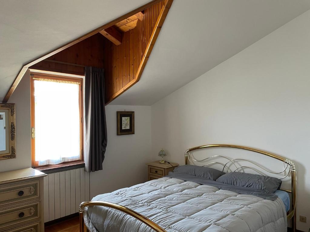 a bedroom with a bed and a window at Relax in Valle D'Aosta da B&G in Aosta