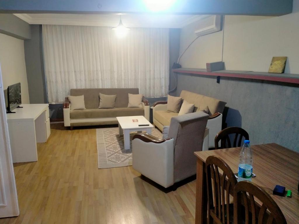 a living room with a couch and a table at 2 bedrooms central area located appartment 1floor in Istanbul