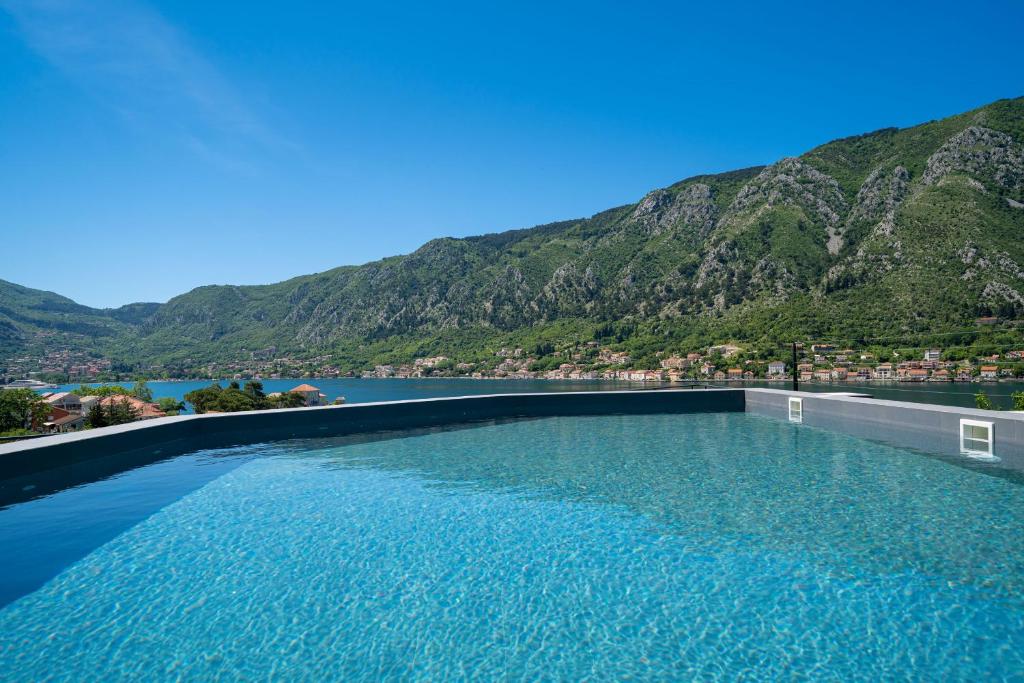 a swimming pool with a view of a mountain at C Group apartments in Kotor