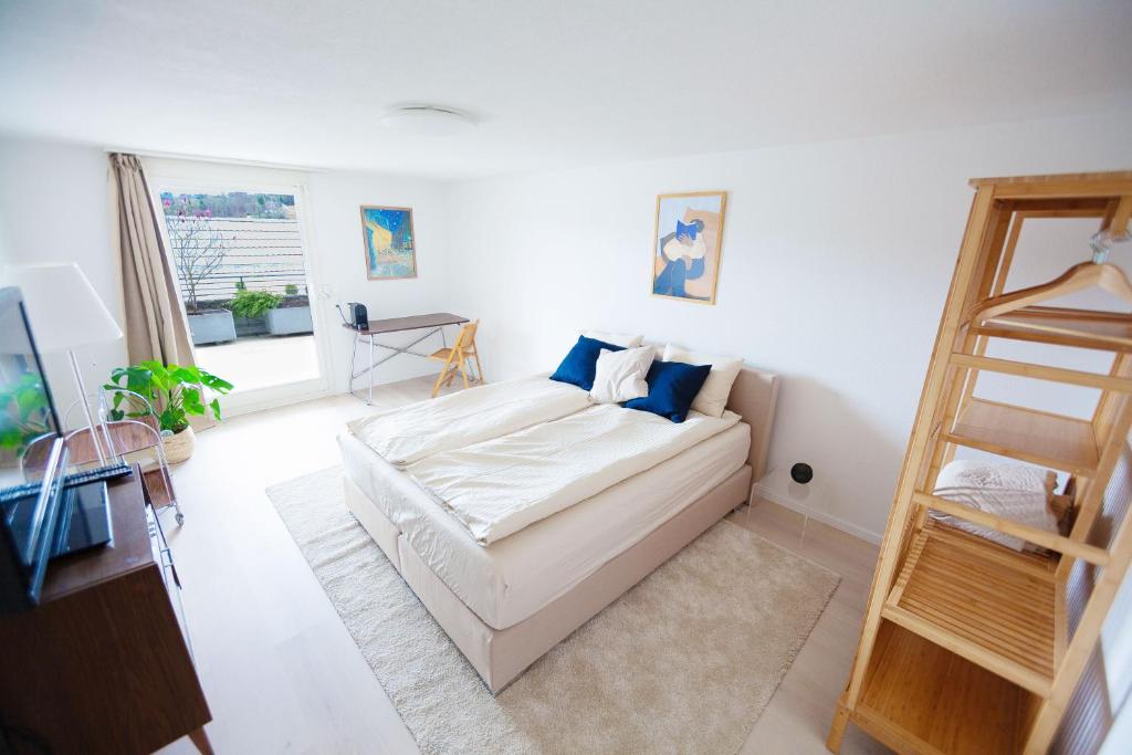 a white living room with a couch and a ladder at Hilltop-house, near train, 180° panorama, friendly in Birmensdorf