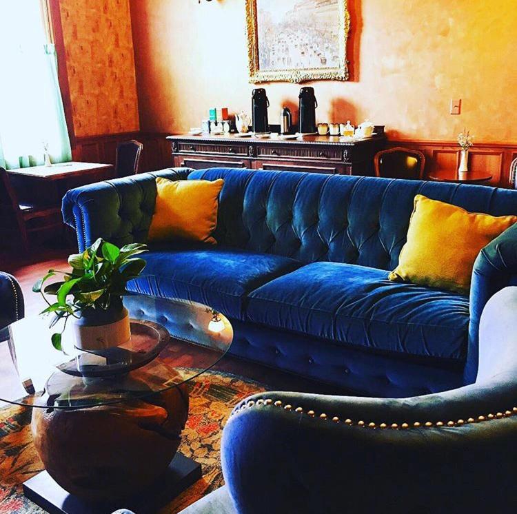 a living room with a blue couch and a table at The Inn at 2nd & C in Eureka
