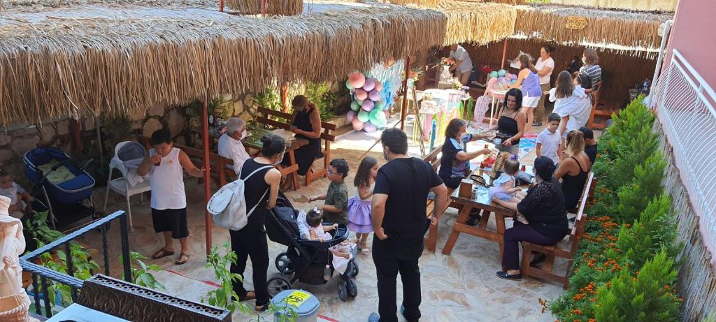 a crowd of people standing around a party in a restaurant at Grand Yayla Hotel in Çeşme