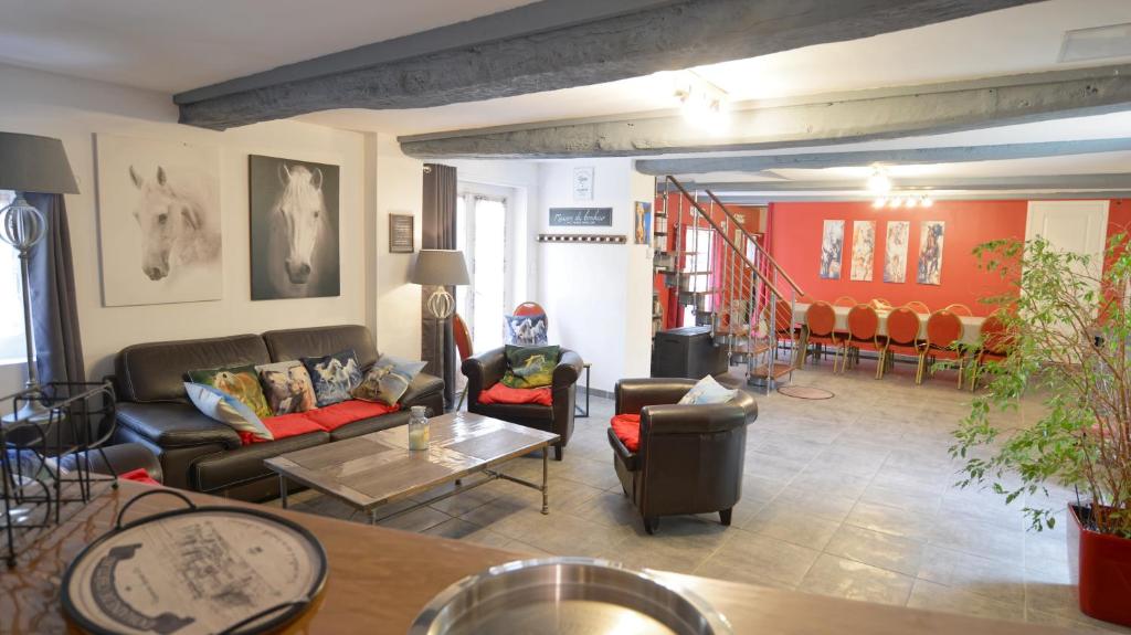 a living room with couches and a table at La Fleur de Sel d'Etretat in Bordeaux-Saint-Clair