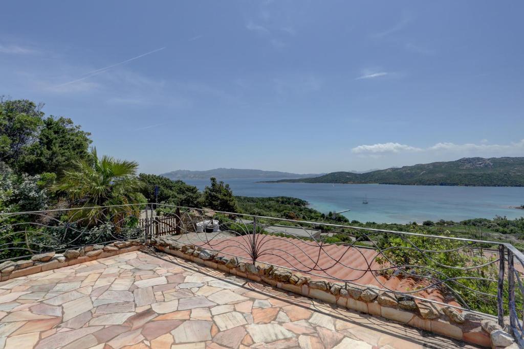 an outdoor patio with a view of the water at VILLA MARIA - CAPO D'ORSO - HOME and MORE in Palau