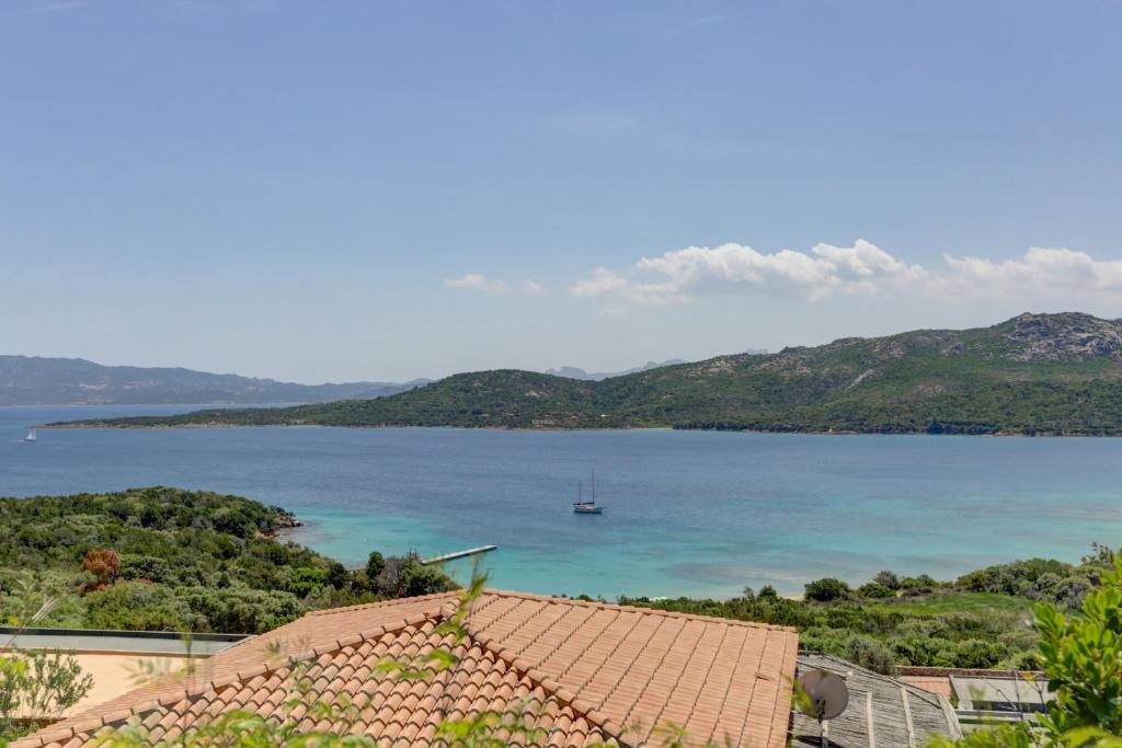 a view of a lake with a boat in the water at VILLA MARIA - CAPO D'ORSO - HOME and MORE in Palau