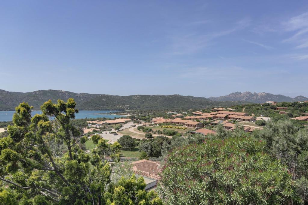 arial view of a resort with a lake and trees at VILLA MARIA - CAPO D'ORSO - HOME and MORE in Palau