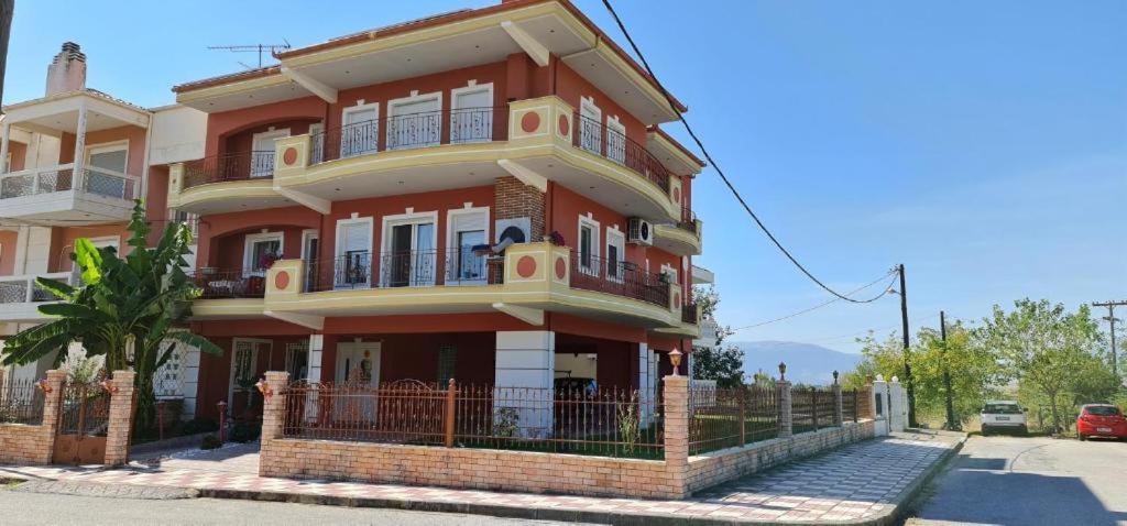 a large orange house with a tree in front of it at Giotas Home in Drama