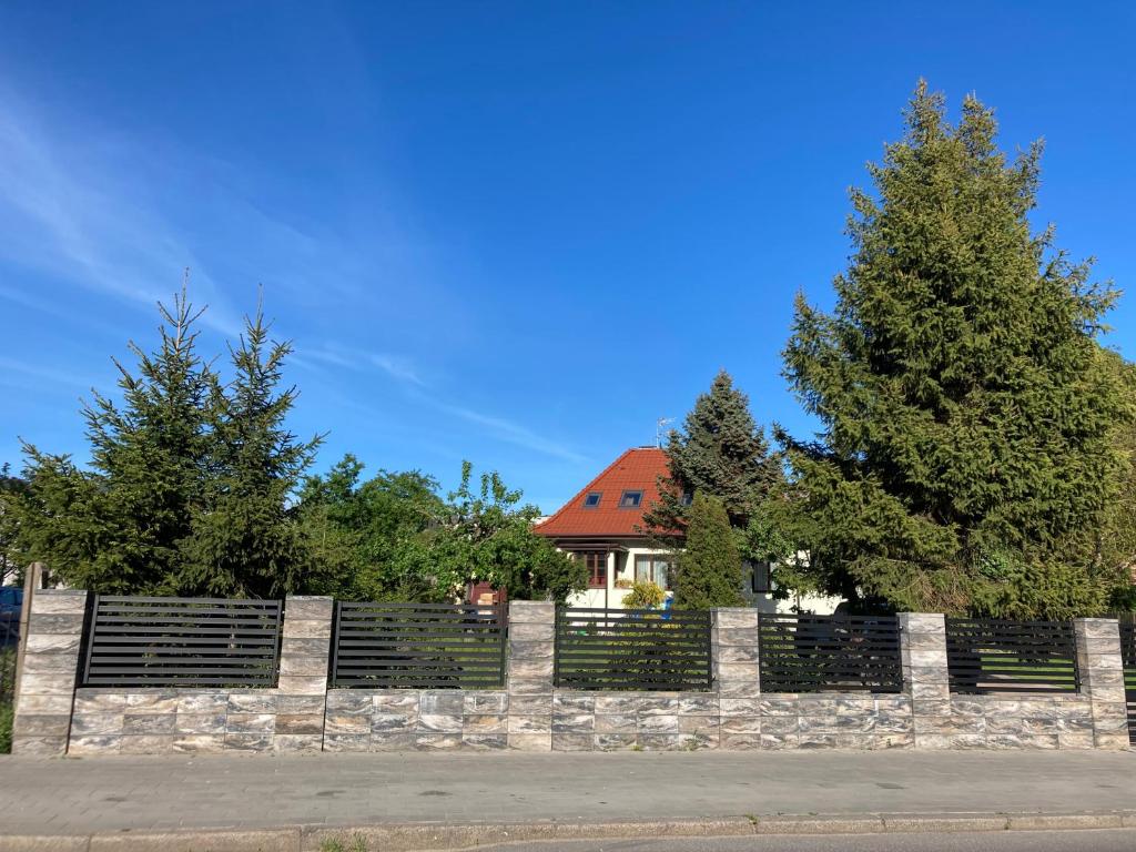 a fence in front of a house with trees at Willa Witkacy in Słupsk