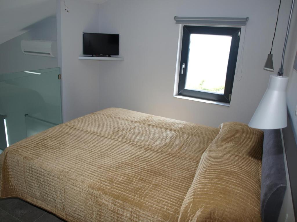Posteľ alebo postele v izbe v ubytovaní Attic Apartments