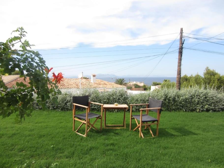 a table and two chairs sitting in the grass at Tranquility?JUST RELAX on the NON-TOURISTIC COAST in Colonia de Sant Pere