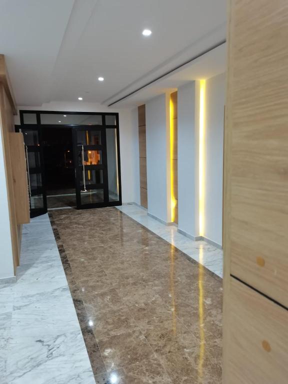 a hallway of a building with a marble floor at Superbe Appartement in Sousse