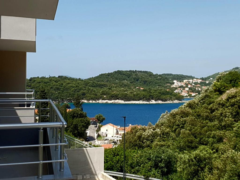 a view of a lake from a balcony of a house at Orchid SeaView Apartment With Garage Parking in Zaton