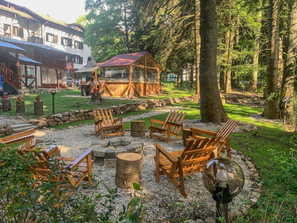a group of wooden chairs and a gazebo at Guest Rooms- KLEPALSKI House in Borovets