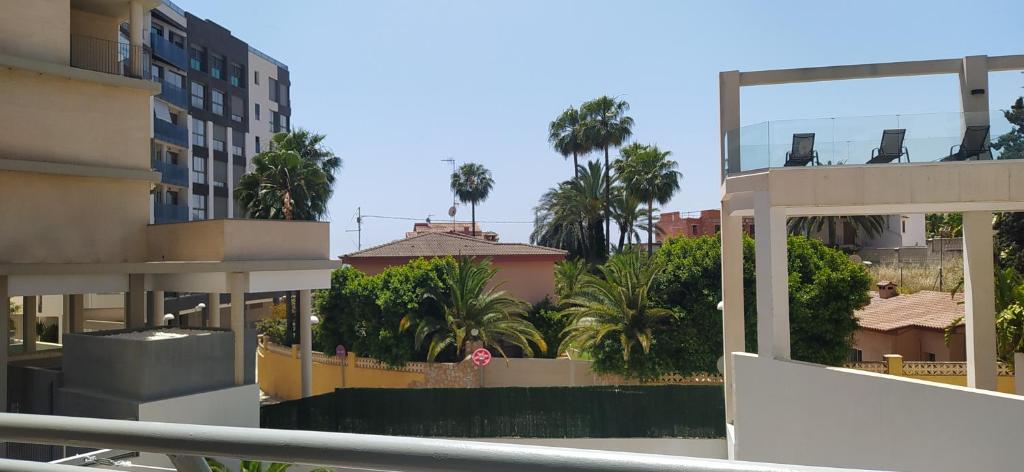 a view of a city with palm trees and buildings at Apartamento el Cid in Calpe