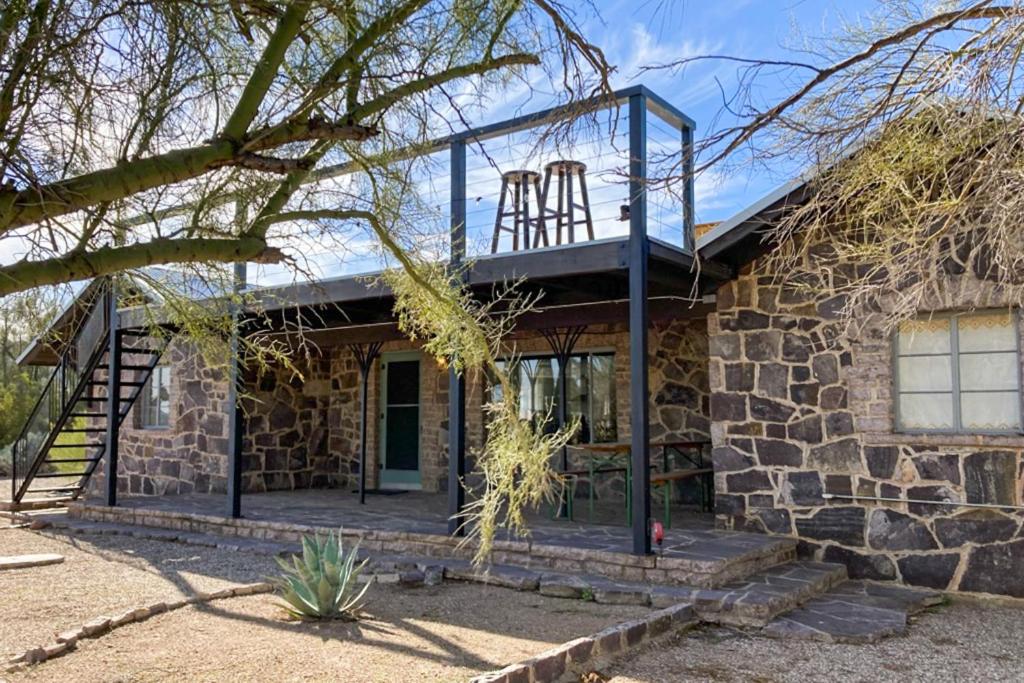 a stone house with a balcony on top of it at Lazy C Ranch in Tucson