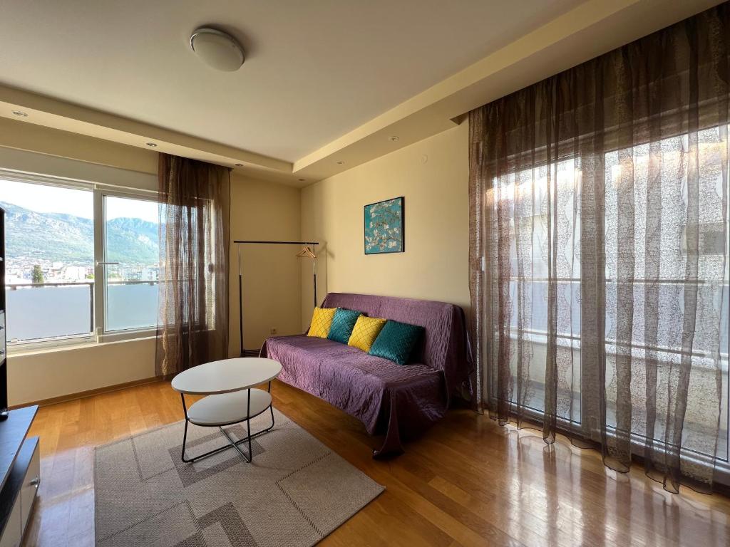 a living room with a purple couch and a table at Apartment SeaView in Bar