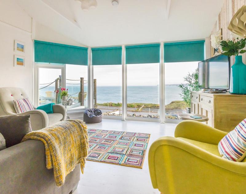 a living room with a view of the ocean at The View in Port Isaac