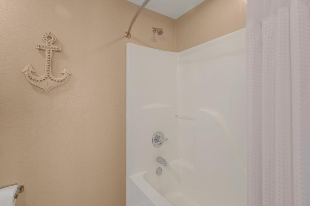 a bathroom with a shower and a cross on the wall at Crystal Tower 1906 by Vacation Homes Collection in Gulf Shores