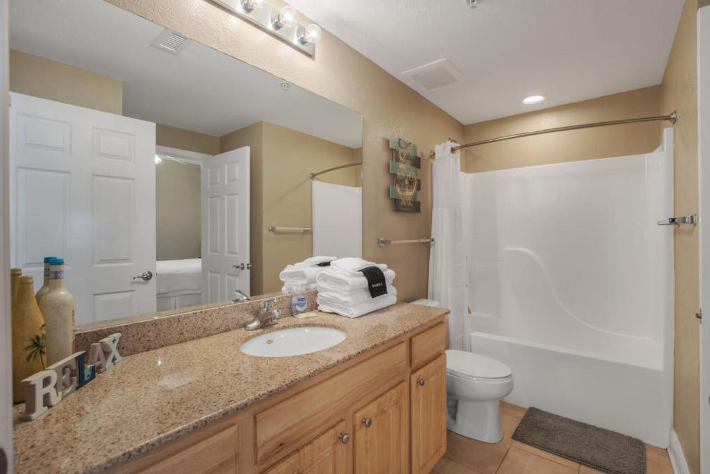 a bathroom with a sink and a toilet and a mirror at Crystal Tower 1906 by Vacation Homes Collection in Gulf Shores