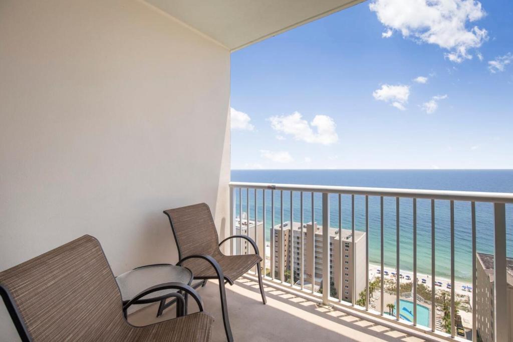 a balcony with two chairs and a view of the ocean at Crystal Tower 1906 by Vacation Homes Collection in Gulf Shores
