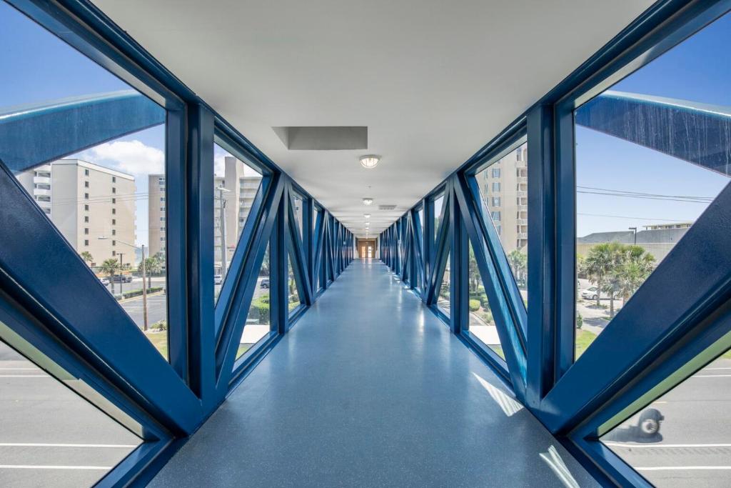 a view of a hallway in a building with blue beams at Crystal Tower 1906 by Vacation Homes Collection in Gulf Shores