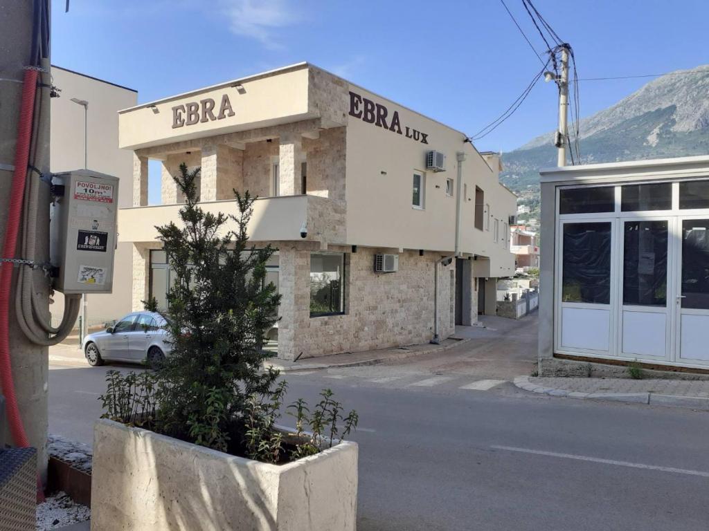 a building on the side of a street at Ebra Lux Apartmani in Dobra Voda