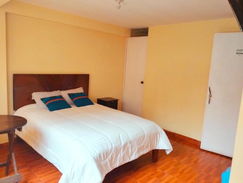 Postel nebo postele na pokoji v ubytování Hostal Ukumari Andino