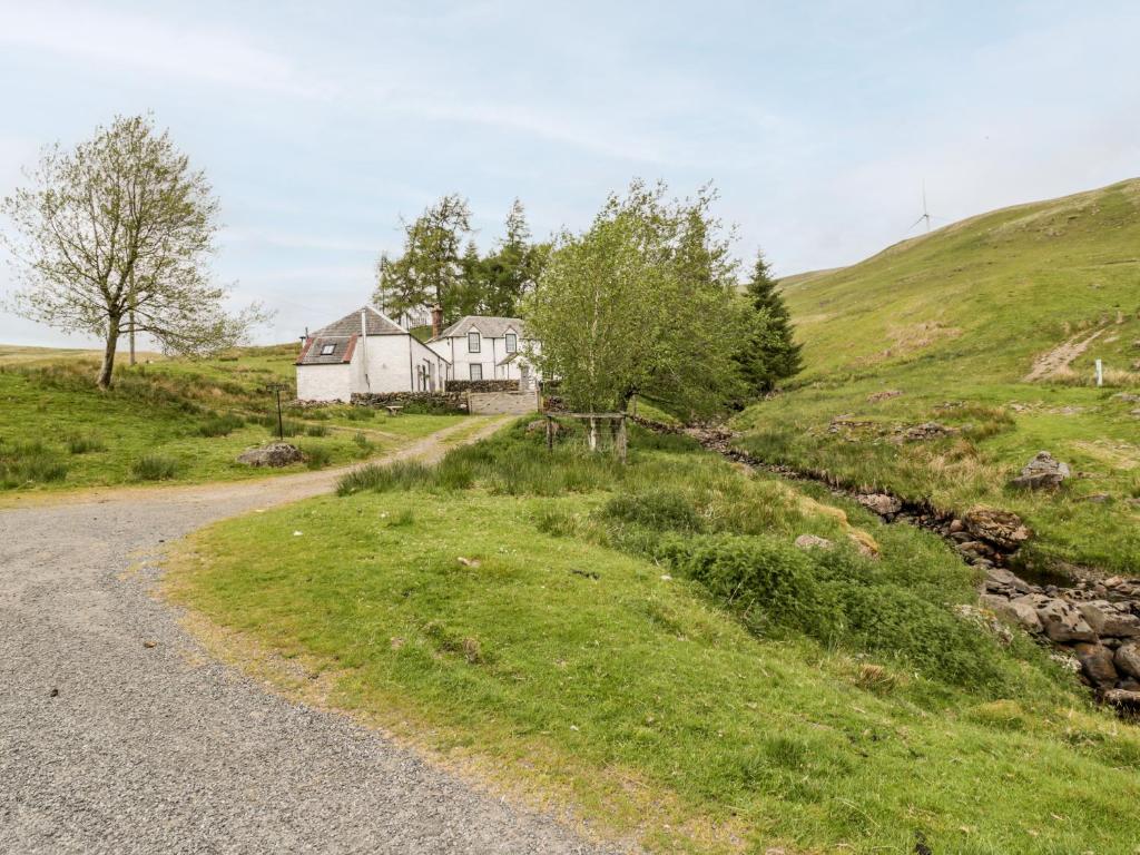 a house on a hill next to a road at Polgowan Barn in Thornhill