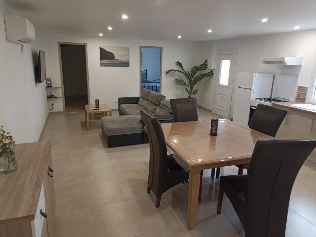 a kitchen and living room with a table and chairs at Le LuMille in Allenay