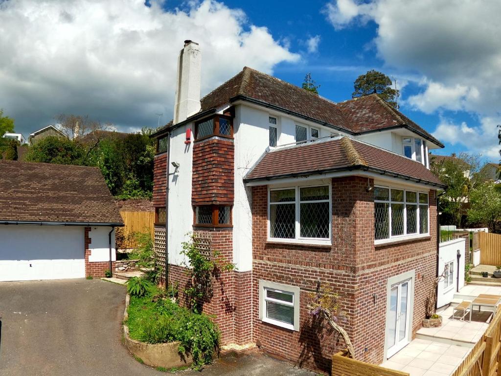 a brick house with a chimney on a street at Harbour Lights in Torquay