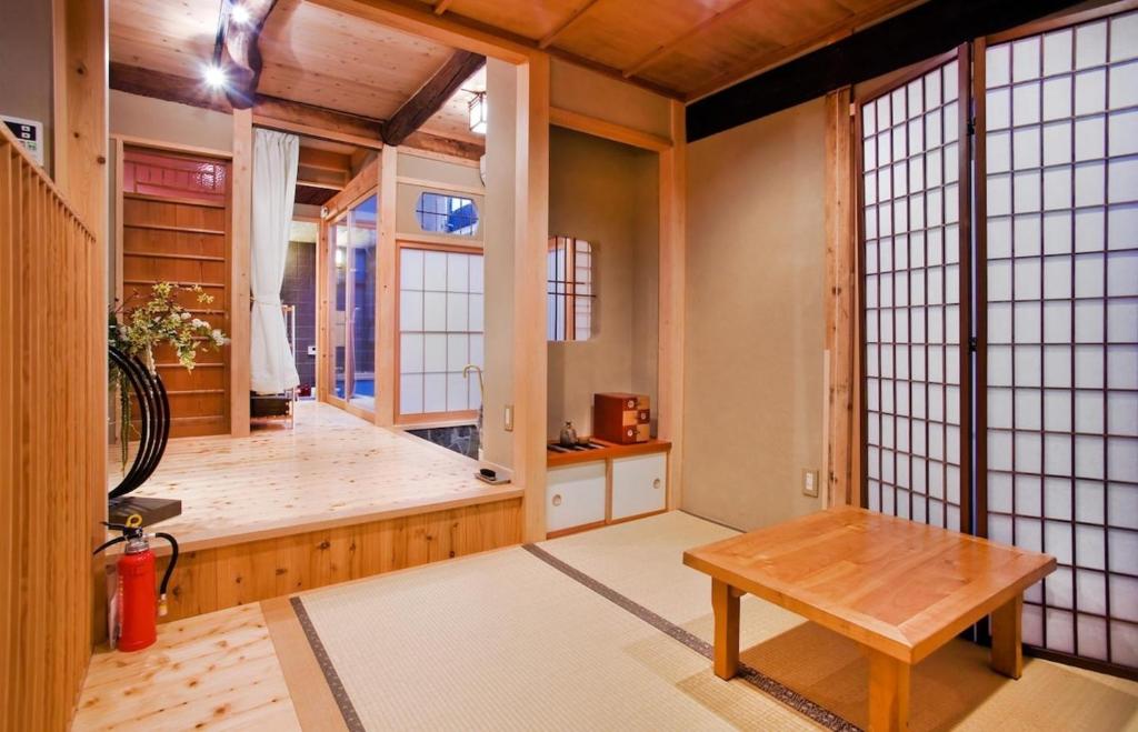 a room with a table and a room with windows at Kyomachiya Amanogawa - Vacation STAY 69288v in Kyoto