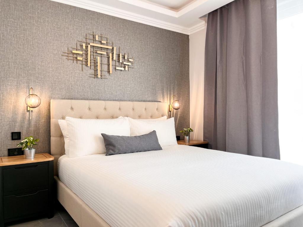 a bedroom with a white bed and a chandelier at Sliema Studios in Sliema