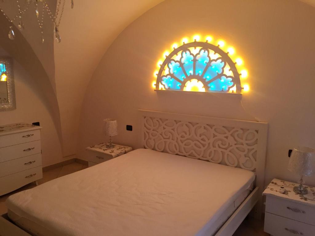 a bedroom with a bed and a stained glass window at Modern Apartment in Gallipoli with Air Conditioning in Gallipoli