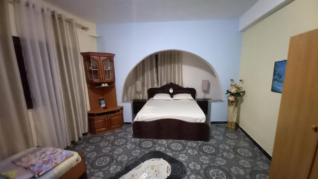 a bedroom with a large bed in a room at Mance Apartment in Durrës