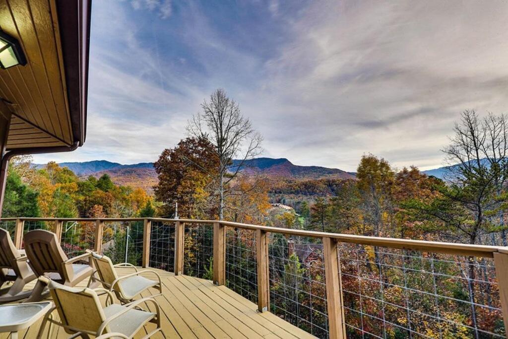 a deck with chairs and a view of the mountains at Hawks View Gatlinburg Mountain Cabin in Gatlinburg