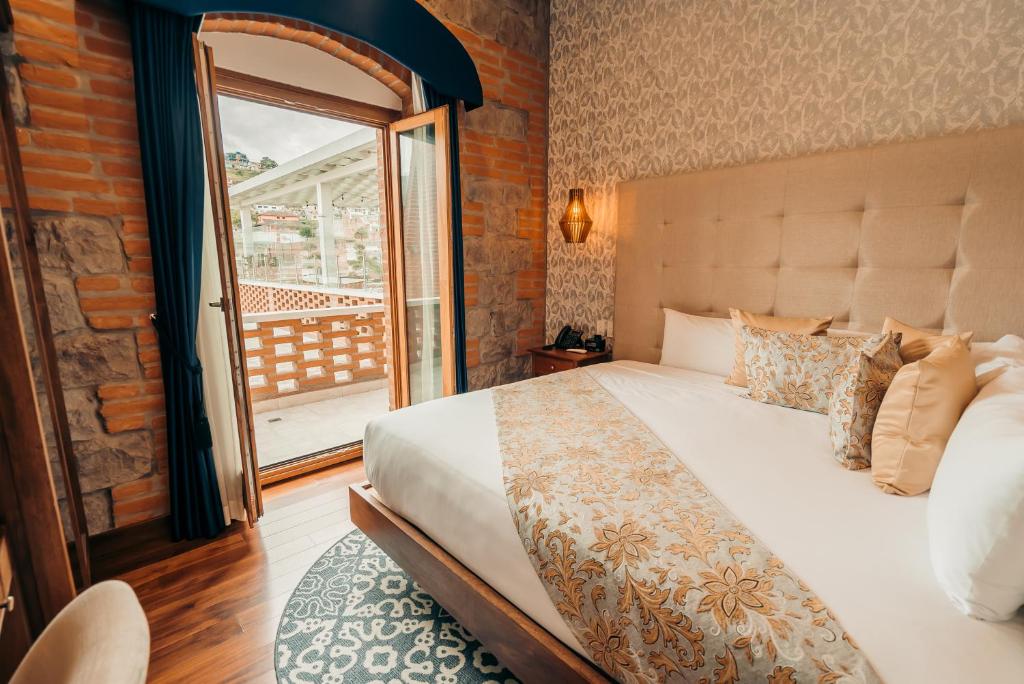 Postel nebo postele na pokoji v ubytování Hotel Otavalo