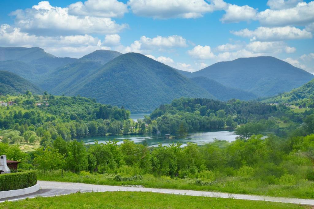 a view of a river with mountains in the background at Apartman RIO in Jajce