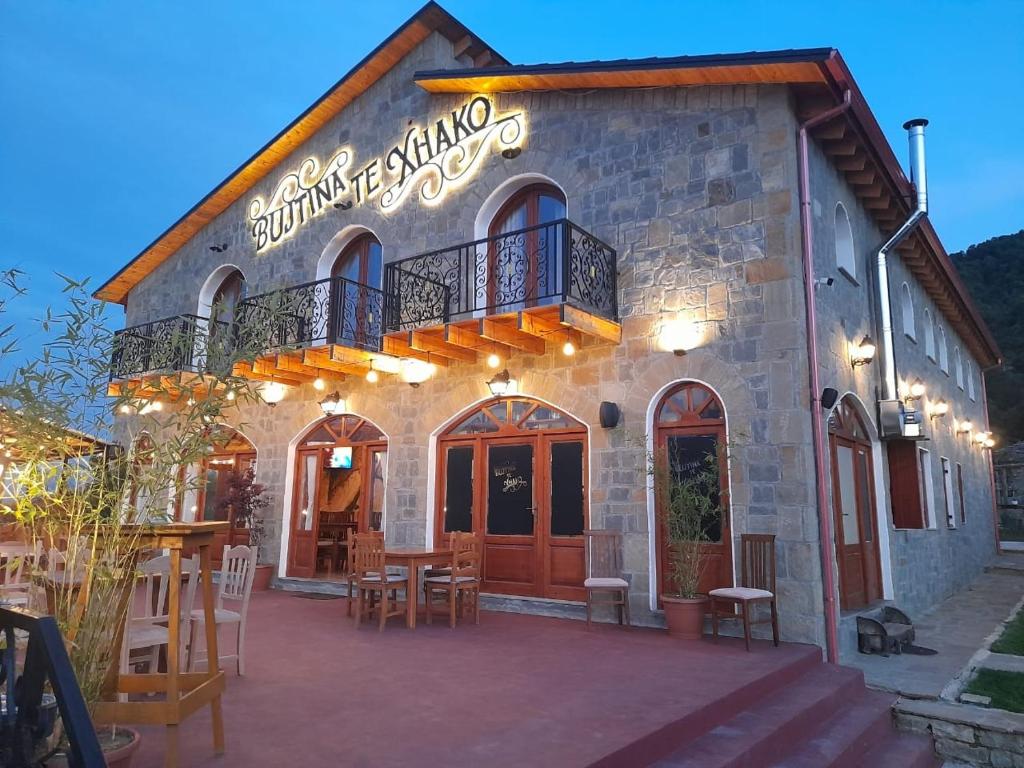a restaurant with tables and chairs in front of a building at Bujtina Te Xhako in Përmet