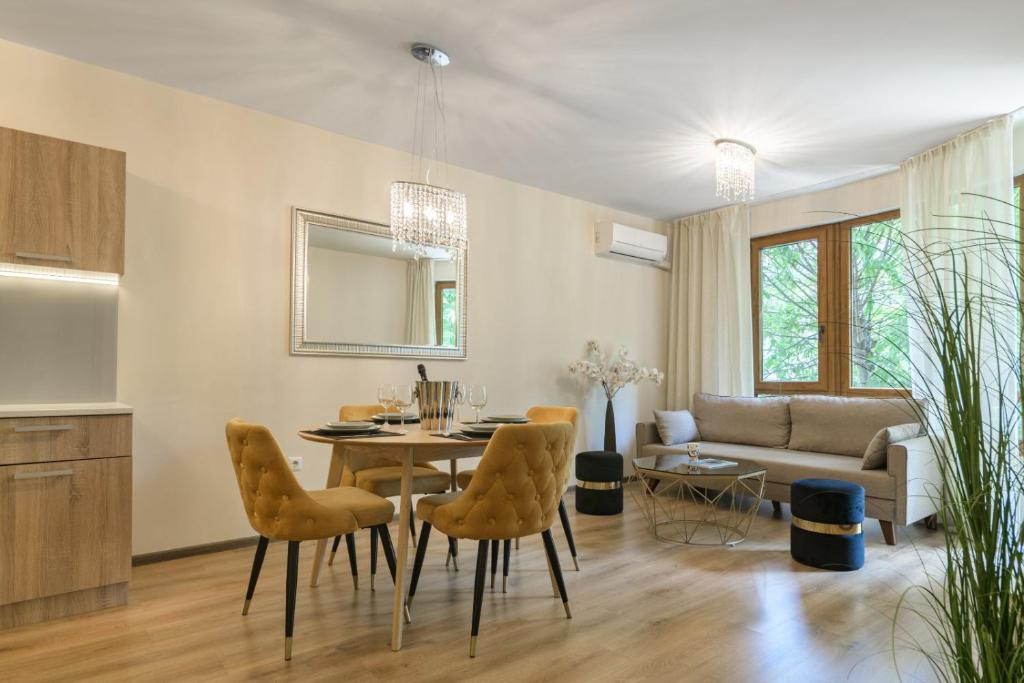 a kitchen and living room with a table and chairs at МareliS Luxe Port Apartment in Varna City
