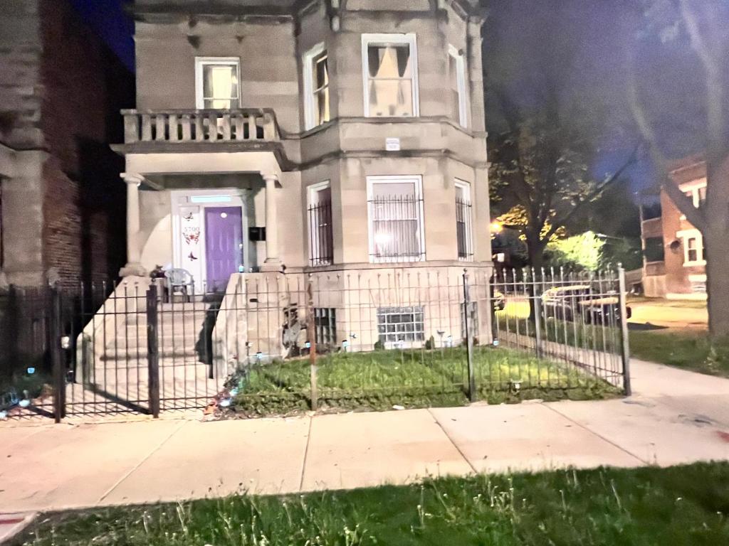 an old house with a gate in front of it at Clean, spacious, inexpensive queen BR in Chicago