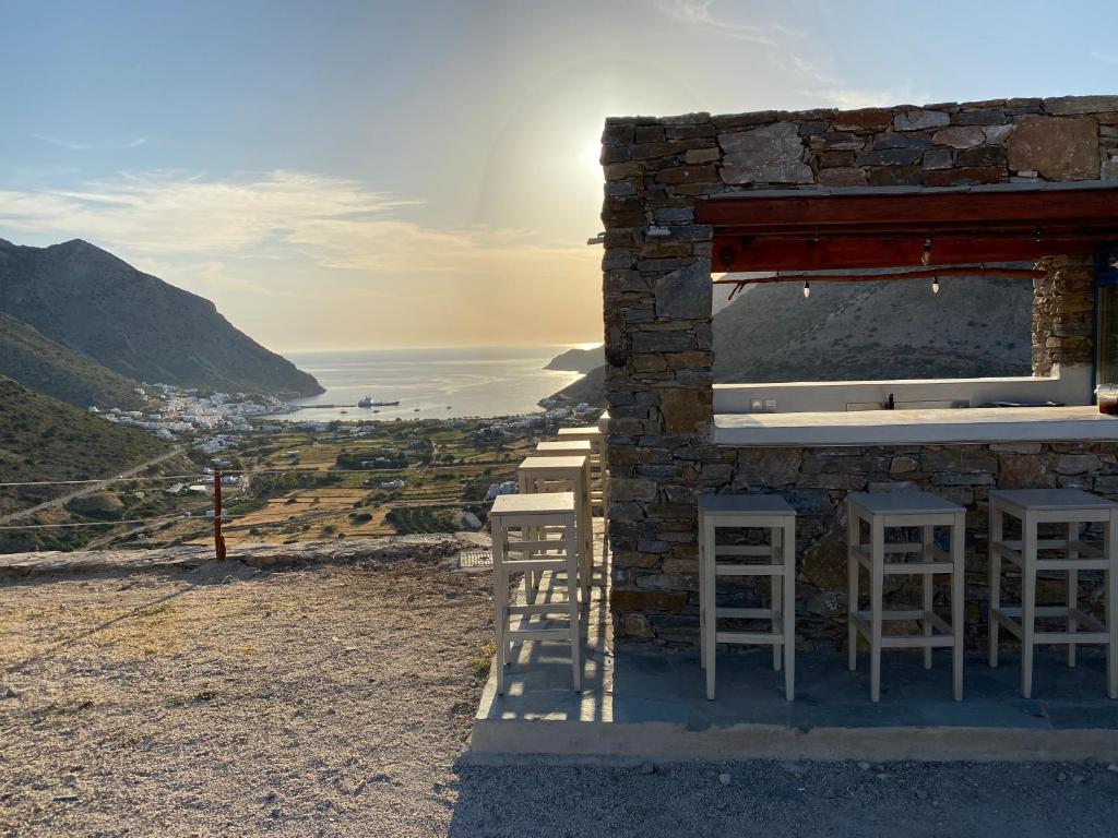 a building with stools and a view of the ocean at Oniropagida in Apollonia