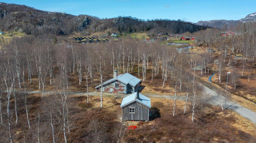 an aerial view of a small house in a forest at Unique cabin Sikringsbua in Sirdal in Tjørhom