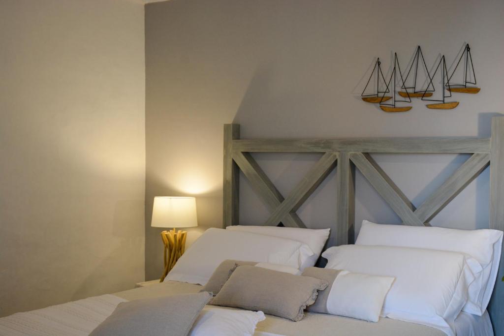 a bedroom with two white beds with sails on the wall at Dimora Lilla in Polignano a Mare