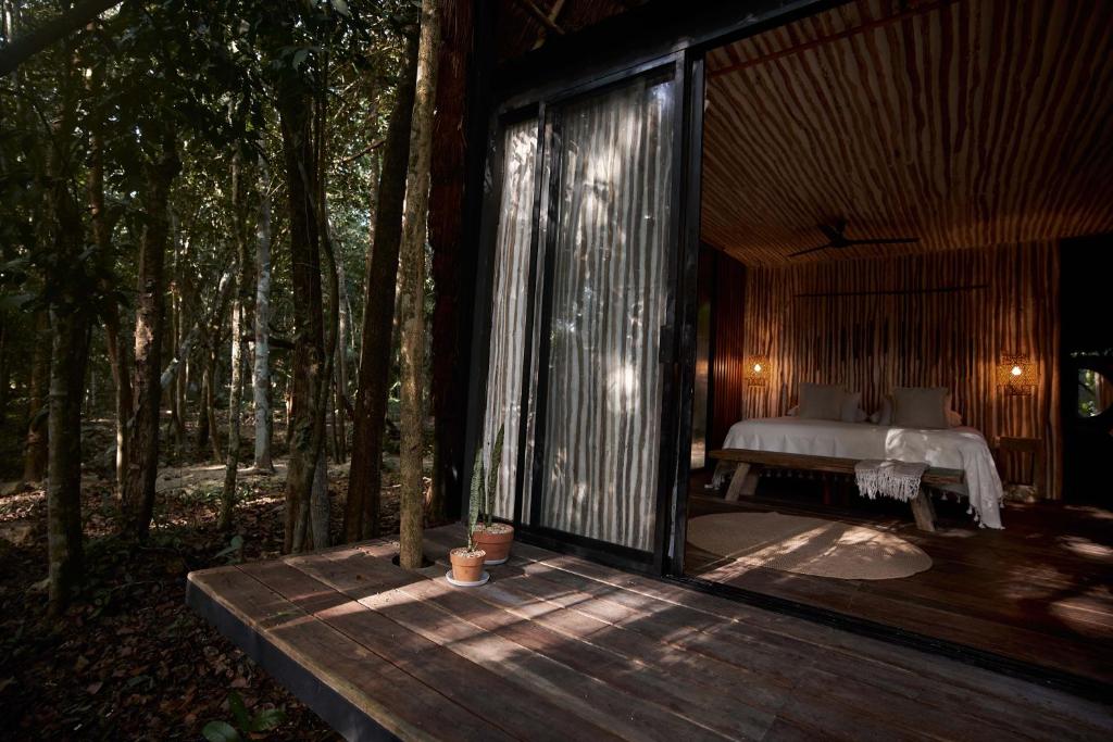 Postel nebo postele na pokoji v ubytování Kapok Bacalar - Plant Based Hotel
