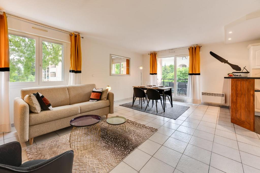 a living room with a couch and a table at The Parc des Raisses - T2 for 4 people in Annecy