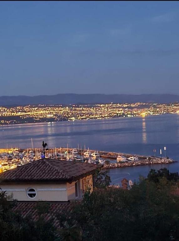 a view of a harbor with a marina at night at Rooms BELA in Ičići