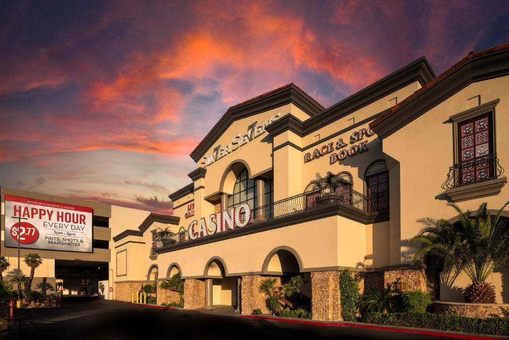 a large white building with a cloudy sky in the background at Silver Sevens Hotel & Casino in Las Vegas