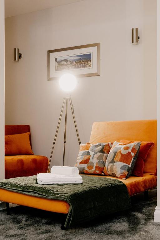 a living room with a couch and a lamp at The Portland in Ashington